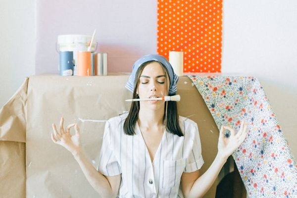 A clean, bright room with a neatly rolled yoga mat on the floor.