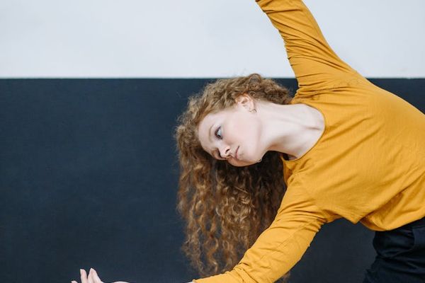 Person in a gentle stretching pose, focusing on fluid movement.